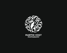 the logo for martin vogt photography is shown in black and white, on a dark background