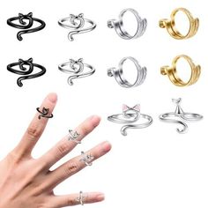 a person's hand with six different rings on their fingers and one ring in the middle