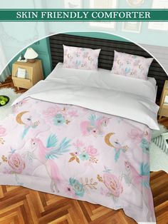 an image of a bed with pink and blue comforters on top of wooden flooring