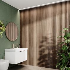 a bathroom with green walls and a white toilet next to a plant in the corner