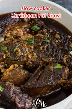 slow cooker caribbean pot roast in a white bowl with garnishes on top