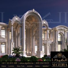 a large white building with many windows and arches on it's sides at night