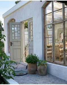 an instagram photo of a house with two potted plants