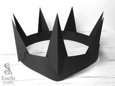 a black paper crown with spikes on it