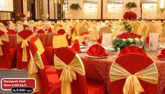 a banquet hall with red and yellow chairs