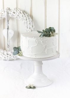 a white wedding cake with succulents on top