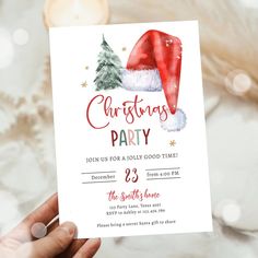 someone holding up a christmas party card