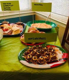 a green table topped with lots of food