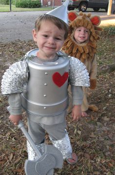 two children dressed up in costumes standing next to each other