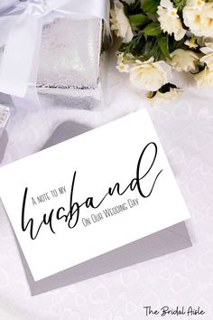 a card with the words husband on it next to some flowers and a gift box