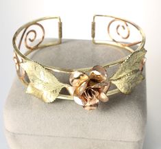 Very sweet KREMENTZ cuff bracelet. It has a two tone, yellow and rose gold fill which creates a lovely color contrast. Center rose is 5/8 inch wide. Bangle is 6 inch long from end to end and opening is 5/8 inch. There is some wear to the gold fill. Cuff Bracelet Gold, Figural Jewelry, Spartanburg Sc, Cuff Jewelry, Gold Bracelet Cuff, Color Contrast, Bracelet Gold, Metal Style, Lovely Colors