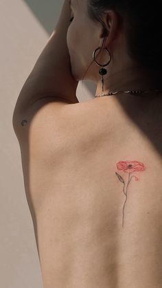 a woman with a flower tattoo on her back