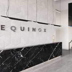 the entrance to an office building with black and white marble