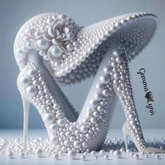 a pair of high heeled shoes made out of pearls