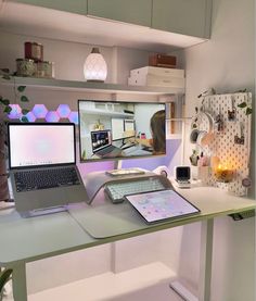 a laptop computer sitting on top of a desk next to a desktop computer monitor and keyboard