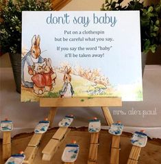 a wooden easer holding some baby toothbrushes and a sign that says, don't say baby