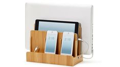 an ipad, tablet and pen holder with two phones in it on a white background