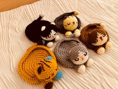 four crocheted cats laying on top of a bed