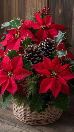 a basket filled with poinsettia and pine cones on top of a wooden table