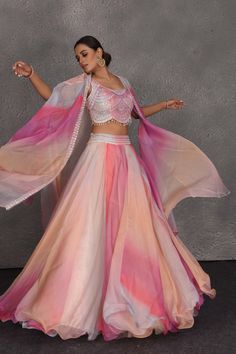 Be the center of attraction at weddings in this one of a kind peach and pink embroidered designer lehenga. It comes with a matching dupatta. DISCLAIMER: The actual product may vary slightly from the image. These are custom orders, hence expect slight variation in color and placement of the motif or buta. ESTIMATED DELIVERY: Because this is a custom order, it would take about 4 weeks from the date of purchase. RETURN POLICY: This product is a custom order and cannot be returned or exchanged. Pink Organza Choli With Gota Work, Peach Georgette Lehenga With Zari Work, Semi-stitched Peach Lehenga With Sheer Dupatta, Peach Lehenga With Sheer Dupatta, Semi-stitched, Semi-stitched Peach Choli With Sheer Dupatta, Peach Semi-stitched Choli With Sheer Dupatta, Peach Semi-stitched Georgette Lehenga, Festive Peach Georgette Lehenga, Peach Resham Embroidery Floor-length Lehenga