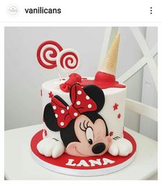 a minnie mouse birthday cake with red and white decorations