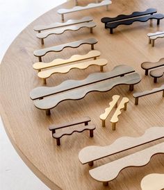 a wooden table topped with lots of different shapes and sizes