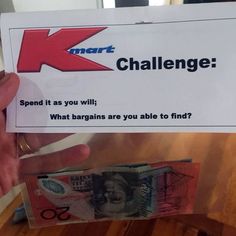 someone holding up a k challenge card with money in it's hand and the letter k on top