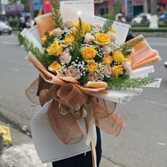 a person holding a bouquet of flowers on the street