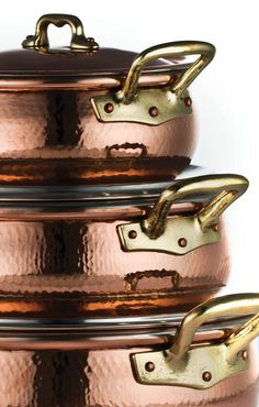 three copper pots stacked on top of each other