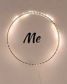 a circle with the word me written on it and some lights in front of it