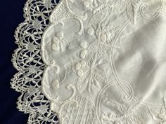 an embroidered white doily on a blue background