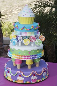 a multi layer cake on top of a purple table