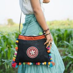 "This Crossbody Bag is made with hemp fabric and vintage Hmong hill tribe embroidery. It comes with adjustable strap. It has a zip opening, 1 zipper pocket inside and colorful pom pom decorations really makes it stand out. Pair this crossbody with something equally as chic and you'll cause fashion envy everywhere you go. We buy materials from Hmong market and we design and sew by hand. Some of the bags we modify to improve the product. The Hmong tribes live in the North of Thailand and have orig Cross Body Bag Pattern, Hmong Embroidery, Pom Pom Decorations, Crochet Free Patterns, Pumpkin Patch Outfit, Free Crochet Bag, Crochet Bag Pattern Free, Stylish Tote Bag, Potli Bags