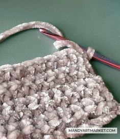 a crochet bag with a pair of scissors on it