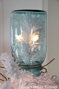 a mason jar filled with snowflakes and lights