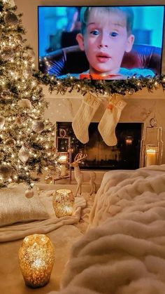 a living room filled with furniture and a christmas tree in front of a flat screen tv