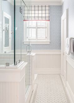 a white bathroom with blue and white tile on the walls