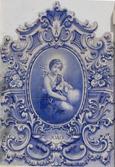 a blue and white tile with a woman holding a dog