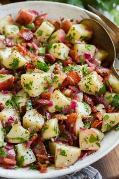 a bowl filled with potato salad on top of a wooden table