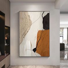 an abstract painting hangs on the wall in a modern living room