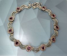 "This unsigned Designer silver tone, Rhodium plated draped link and purple rhinestone floral collar necklace from 1970's. One link is 1.5\" long, the necklace is 16.5\" long, 7/8\" wide  with a lobster claw clasp and 2\" long extended chain. It weighs 3.3 oz.  It is a vintage item we got in Estate sale. High End and Collectible necklace in very good condition. We combine shipping.  Thank You for visiting our Etsy https://www.etsy.com/shop/VictoryIssweet store!" Formal Purple Metal Necklace, Vintage Purple Jewelry With Rhinestones, Vintage Purple Rhinestone Jewelry, Purple Vintage Jewelry With Rhinestones, Gala Jewelry, Rhinestone Collar, Trifari Jewelry, Purple Rhinestone, Choker Necklaces