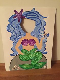 a card with an image of a mermaid holding a starfish on it's back