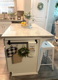 a kitchen island with pots and pans hanging from it's hooks on the door