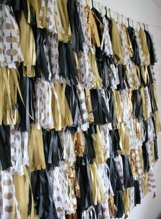 the wall is covered with black, gold and white ribbons