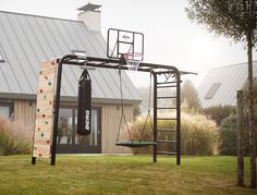 a basketball hoop and gym equipment in front of a house