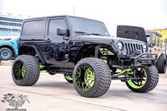 a black jeep with neon green wheels and tires