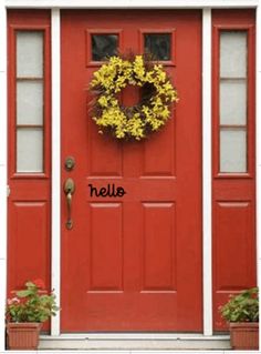 a red door with a yellow wreath on it