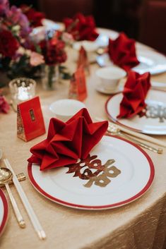 the table is set with red napkins and silverware