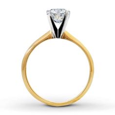 a yellow gold engagement ring with a single diamond in the center, on a white background