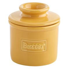 a yellow butter canister with a lid on the front and bottom, sitting against a white background